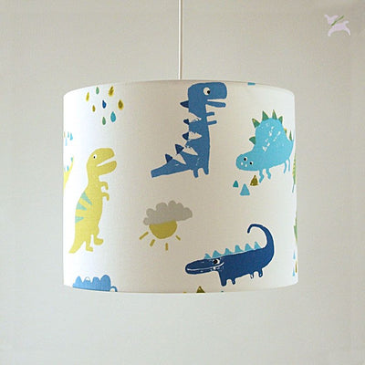 Stofflampenschirm-dinos-in blau-gelb-auf-weiss