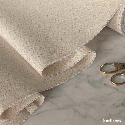 detailfoto-von-dekostoff-meterware-rolle-in creme-mit-eingewebtem-goldfaden